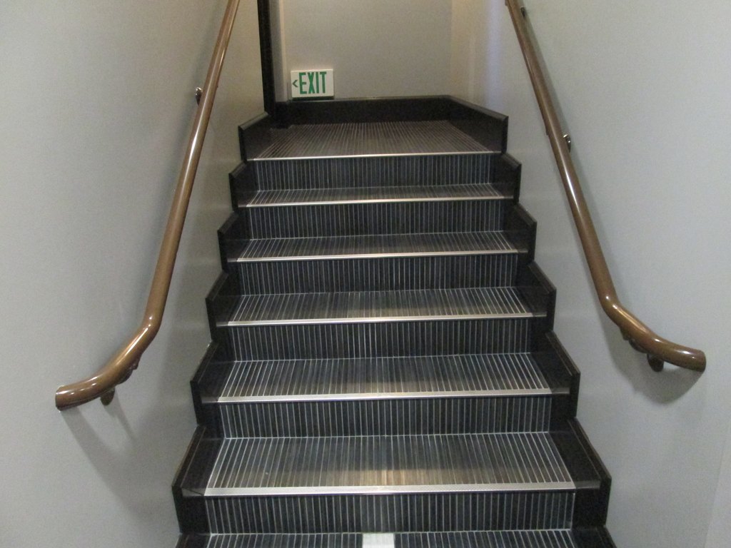 Interior exit stair with handrails on both sides, reviewed for ADA stair requirements
