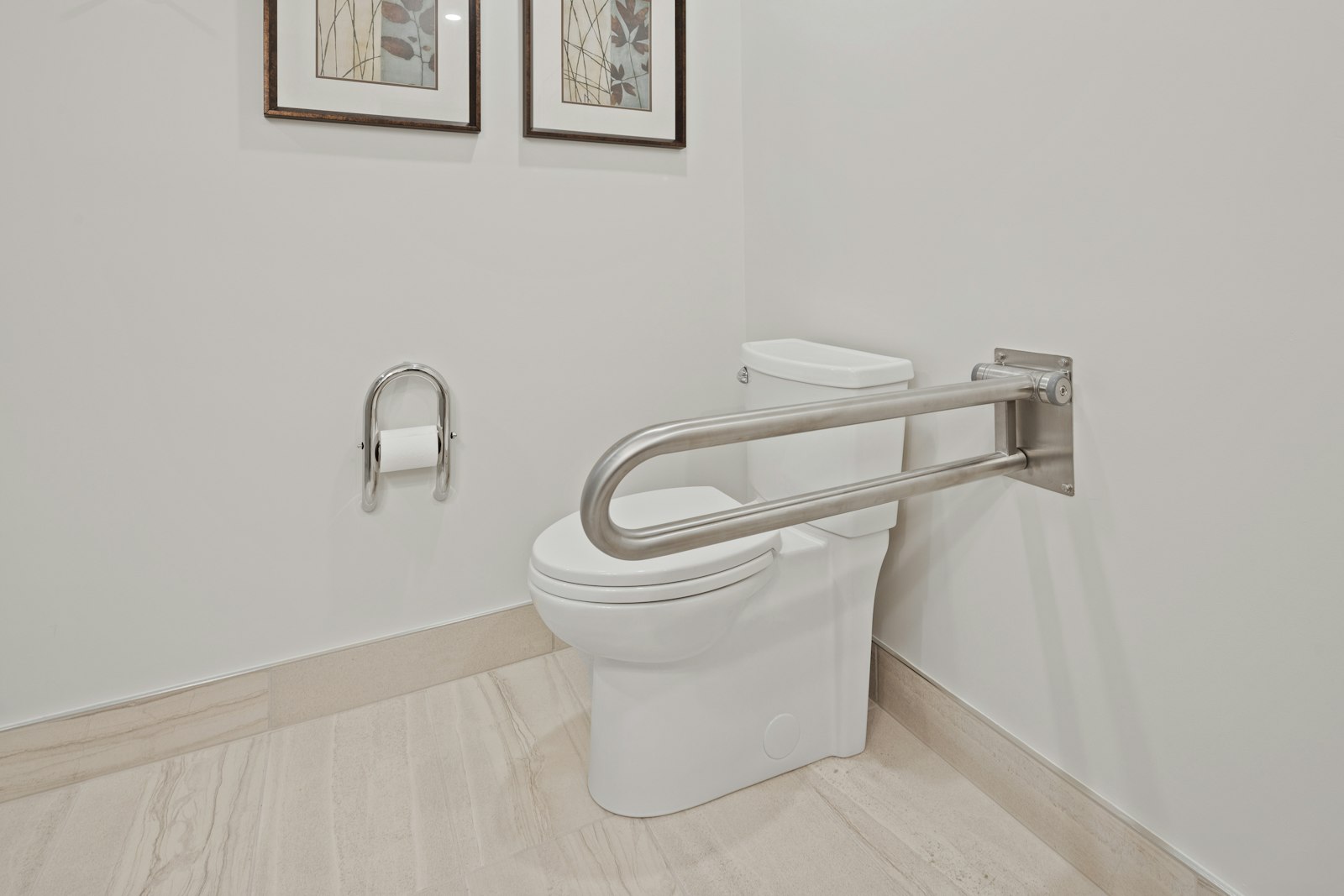 ADA restroom with side grab bar, toilet and toilet paper dispenser in an accessible layout